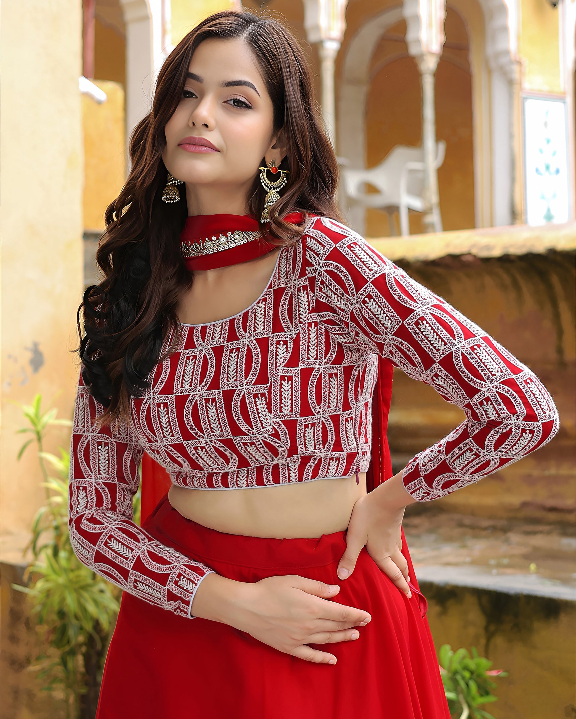 Woman wearing a red and white traditional outfit with a blurred background