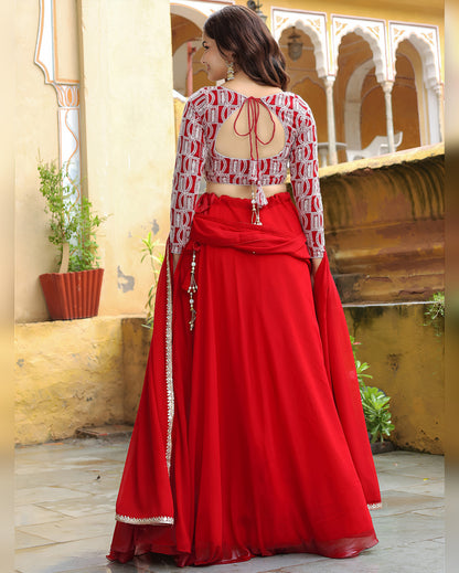 Woman wearing a red and white traditional outfit with a yellow architectural background