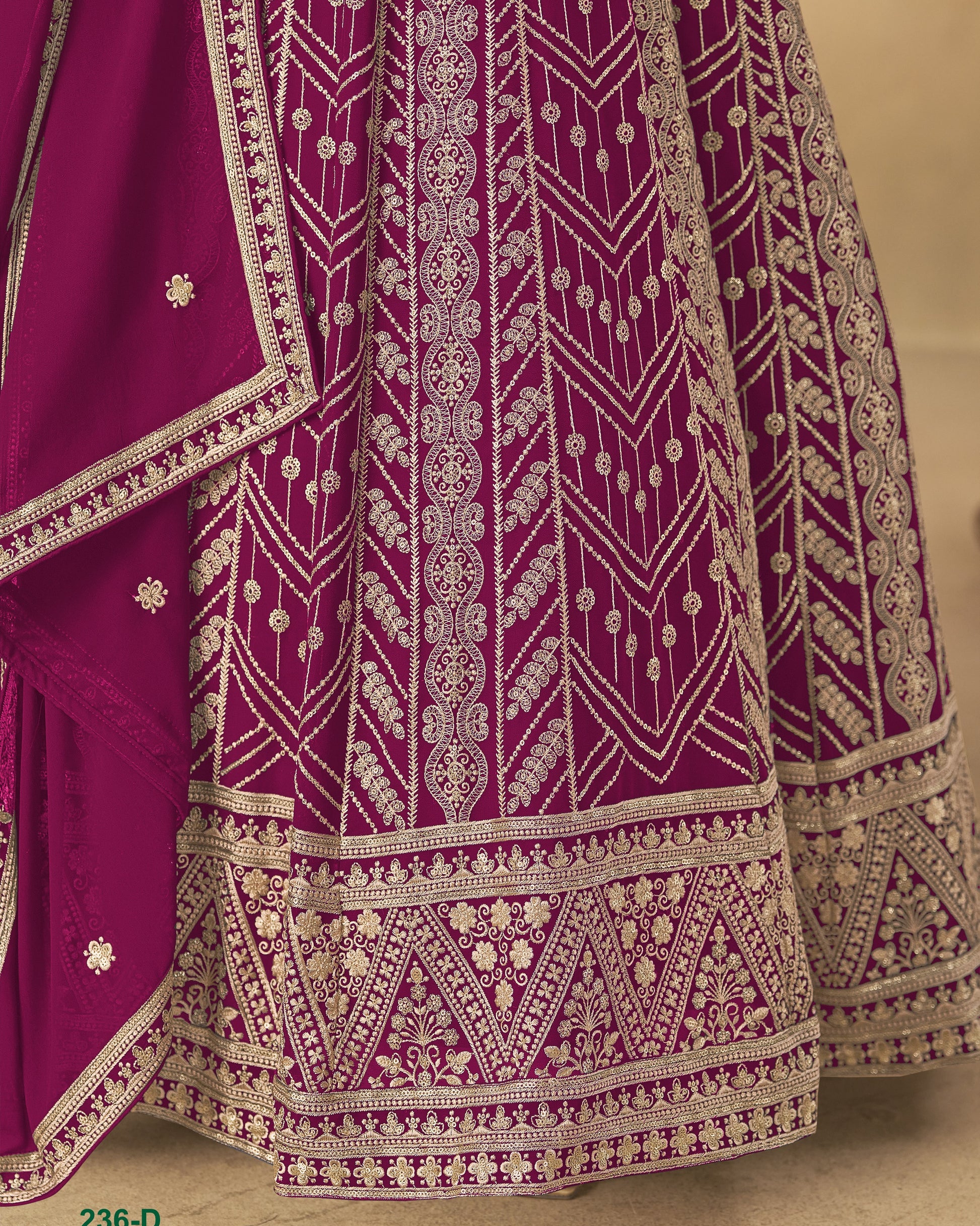 Purple traditional outfit with intricate white embroidery on a beige background
