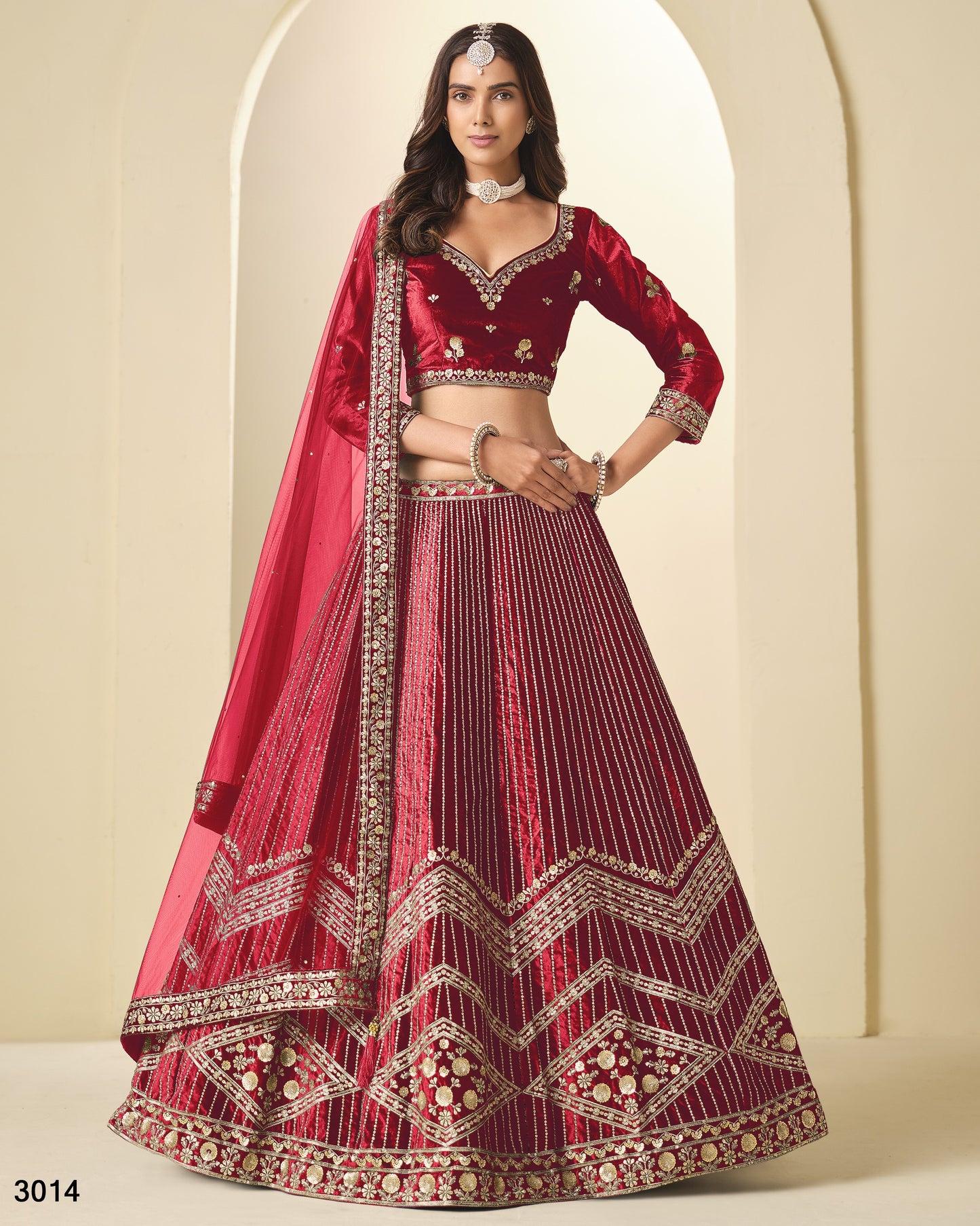 Red embroidered lehenga with matching blouse on a neutral background