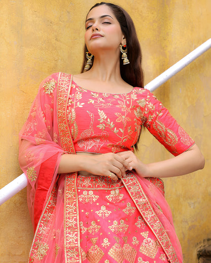 Woman wearing a pink traditional outfit with gold embroidery against a yellow background