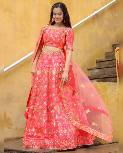 Woman wearing a pink embroidered lehenga with a yellow background