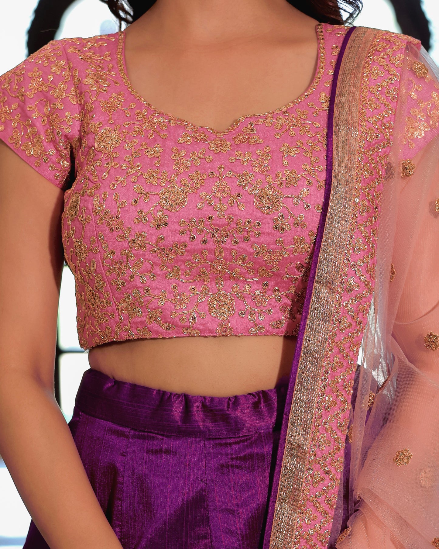 Pink embroidered blouse with purple saree and white blouse