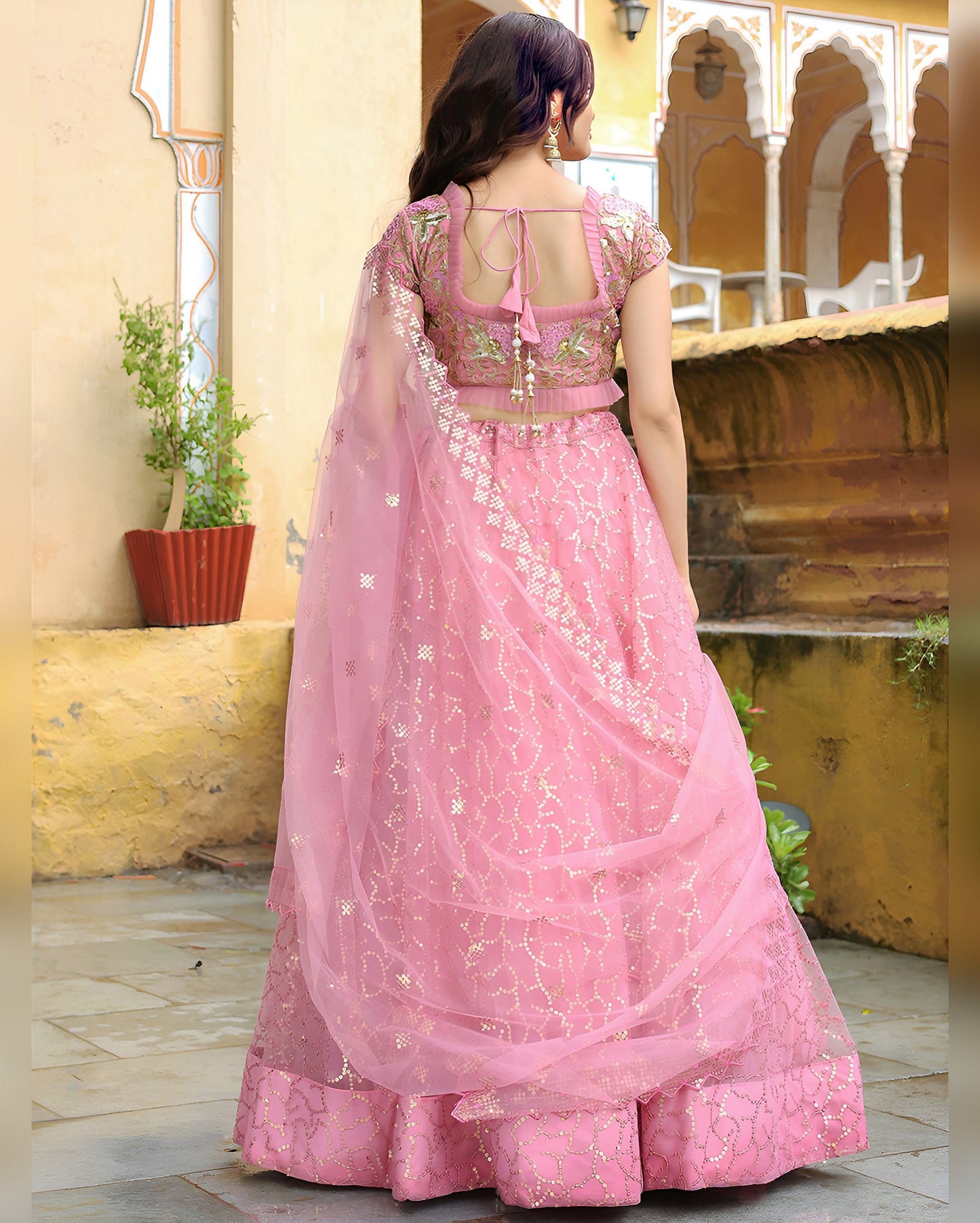 Woman wearing a pink traditional outfit with a blurred background