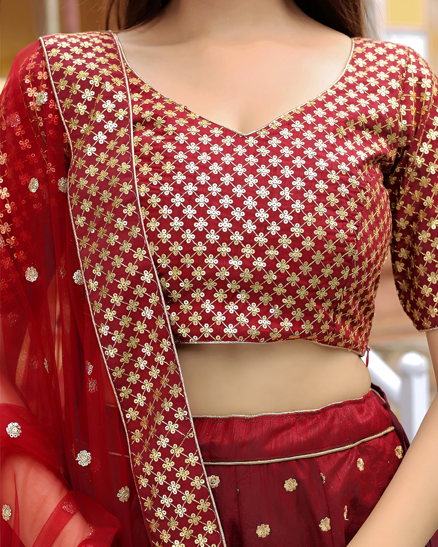 Red saree with gold patterns and a matching blouse