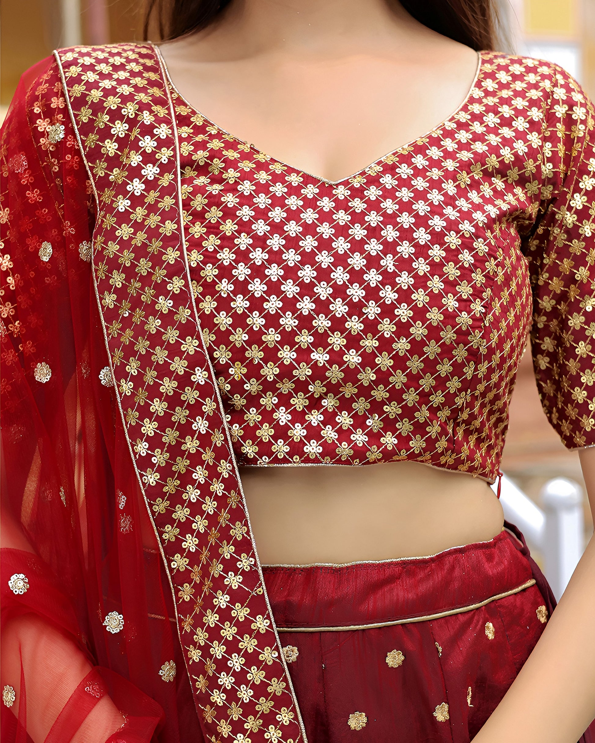 Red saree with gold patterns and a matching blouse