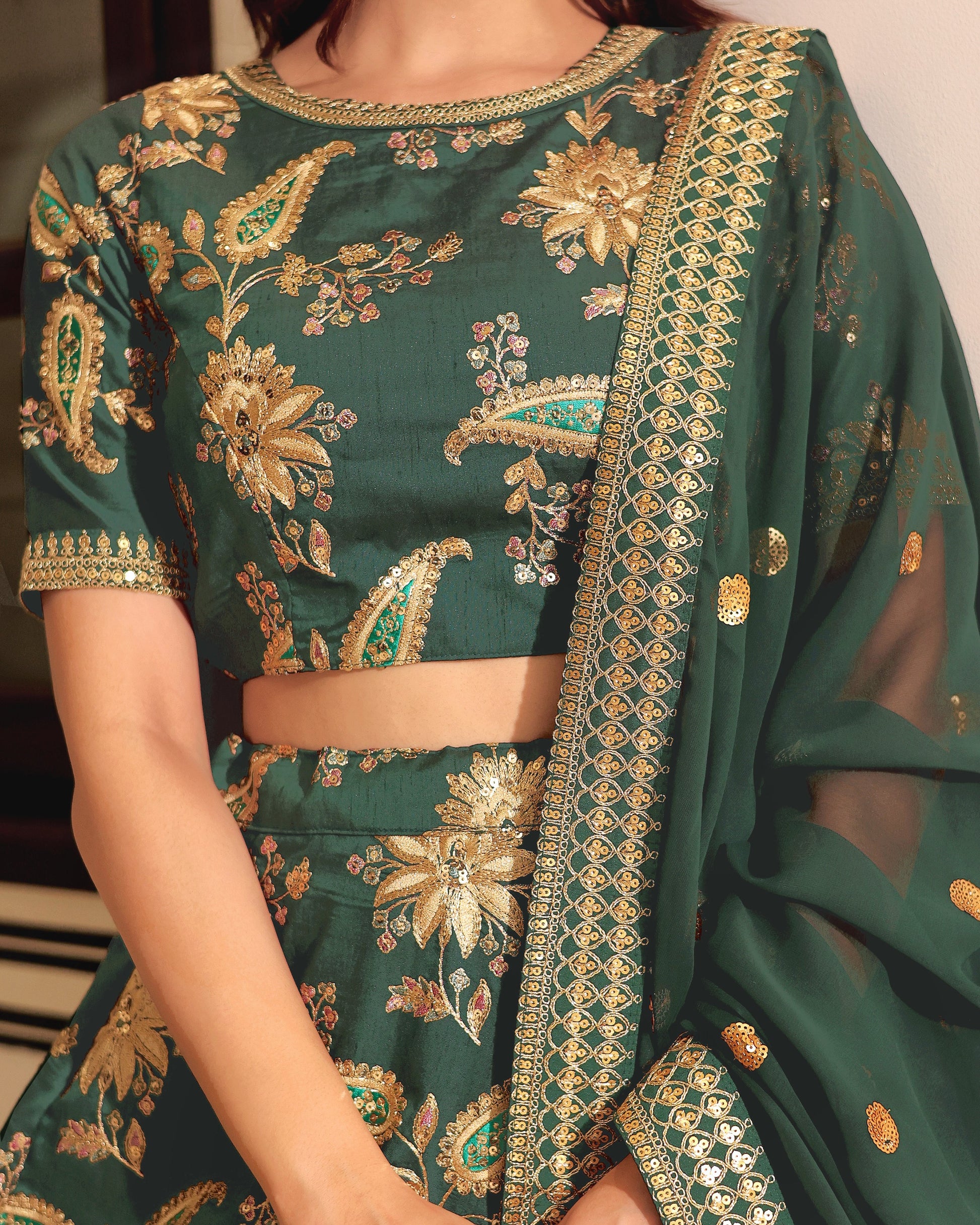 Green embroidered traditional outfit with gold details