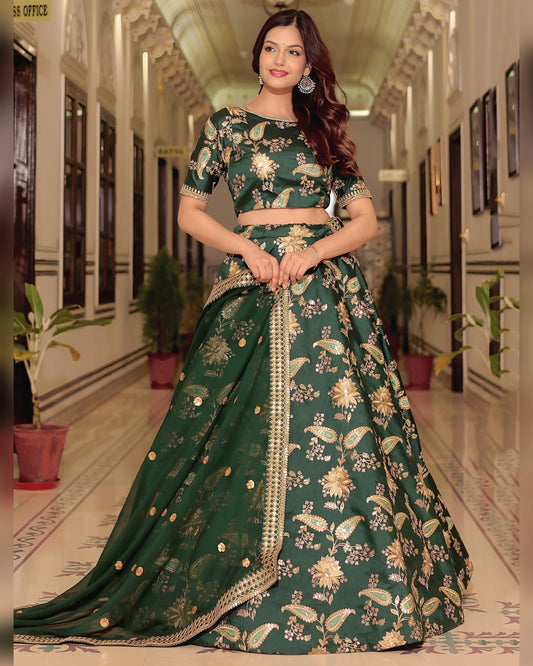 Woman wearing a green floral lehenga in an indoor setting