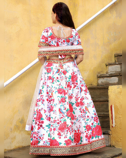 Woman wearing a floral dress standing against a yellow wall.