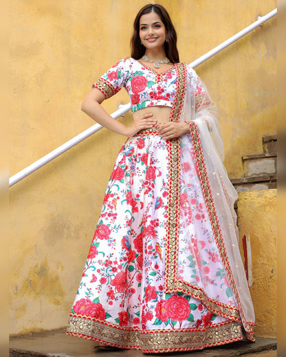 Woman wearing a floral lehenga with a yellow wall background