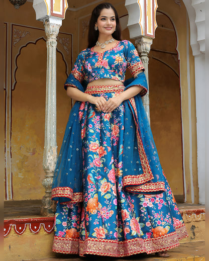 Woman wearing a blue floral traditional outfit in an ornate indoor setting
