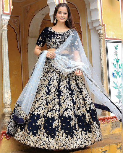 Woman in a black and white patterned dress with a sheer dupatta in an ornate indoor setting.