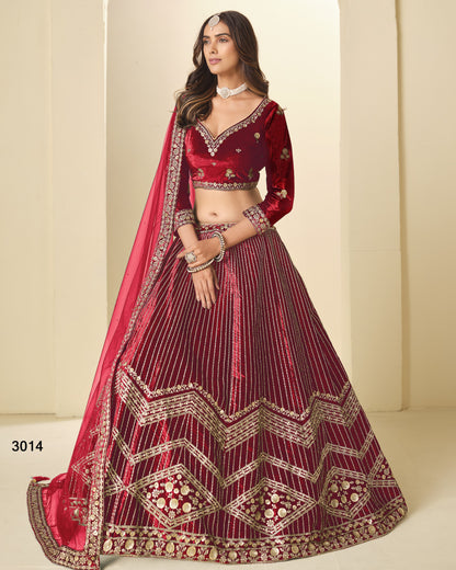 Woman wearing a red and maroon embroidered traditional outfit on a beige background