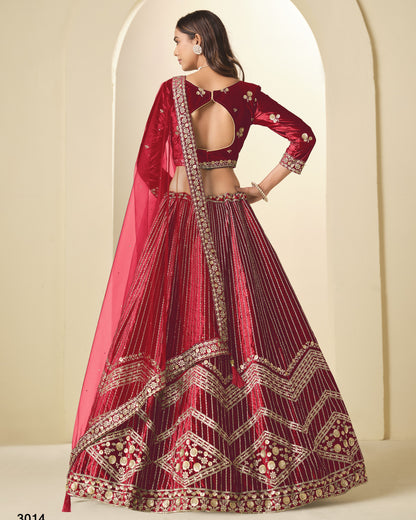 Red embroidered traditional outfit with a pink dupatta against a neutral background