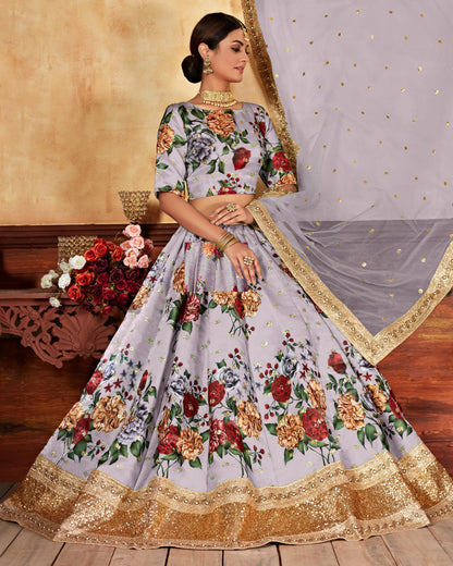 Woman wearing a floral lehenga with a gold border, standing against a neutral background.