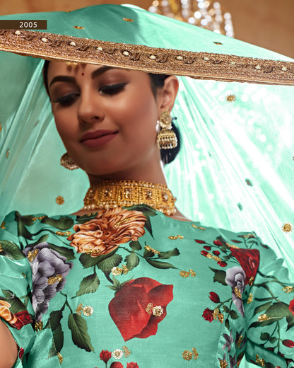 Woman wearing a traditional outfit with floral patterns and gold jewelry, with a focus on the headscarf and floral blouse.