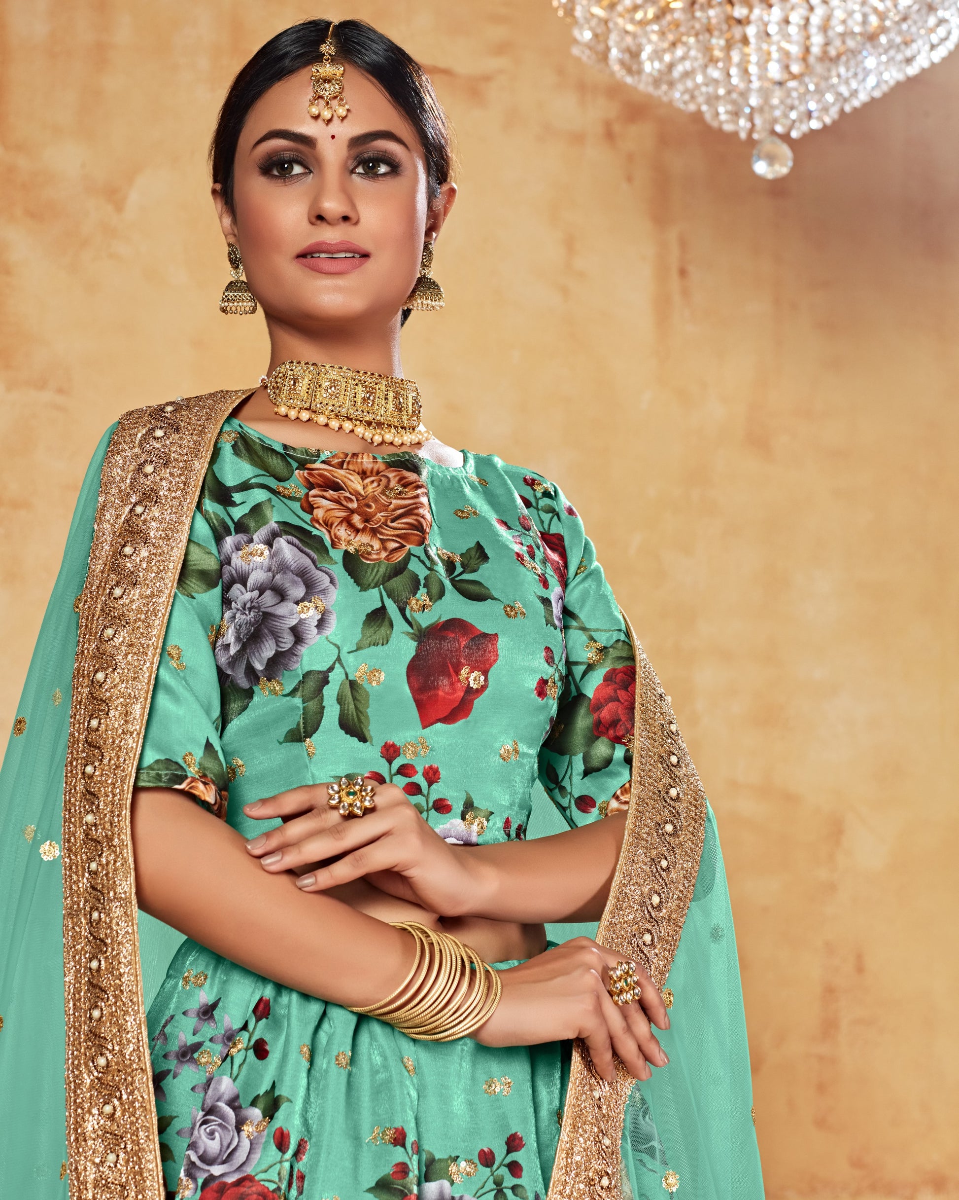 Woman in traditional attire with floral design and gold accents on a beige background