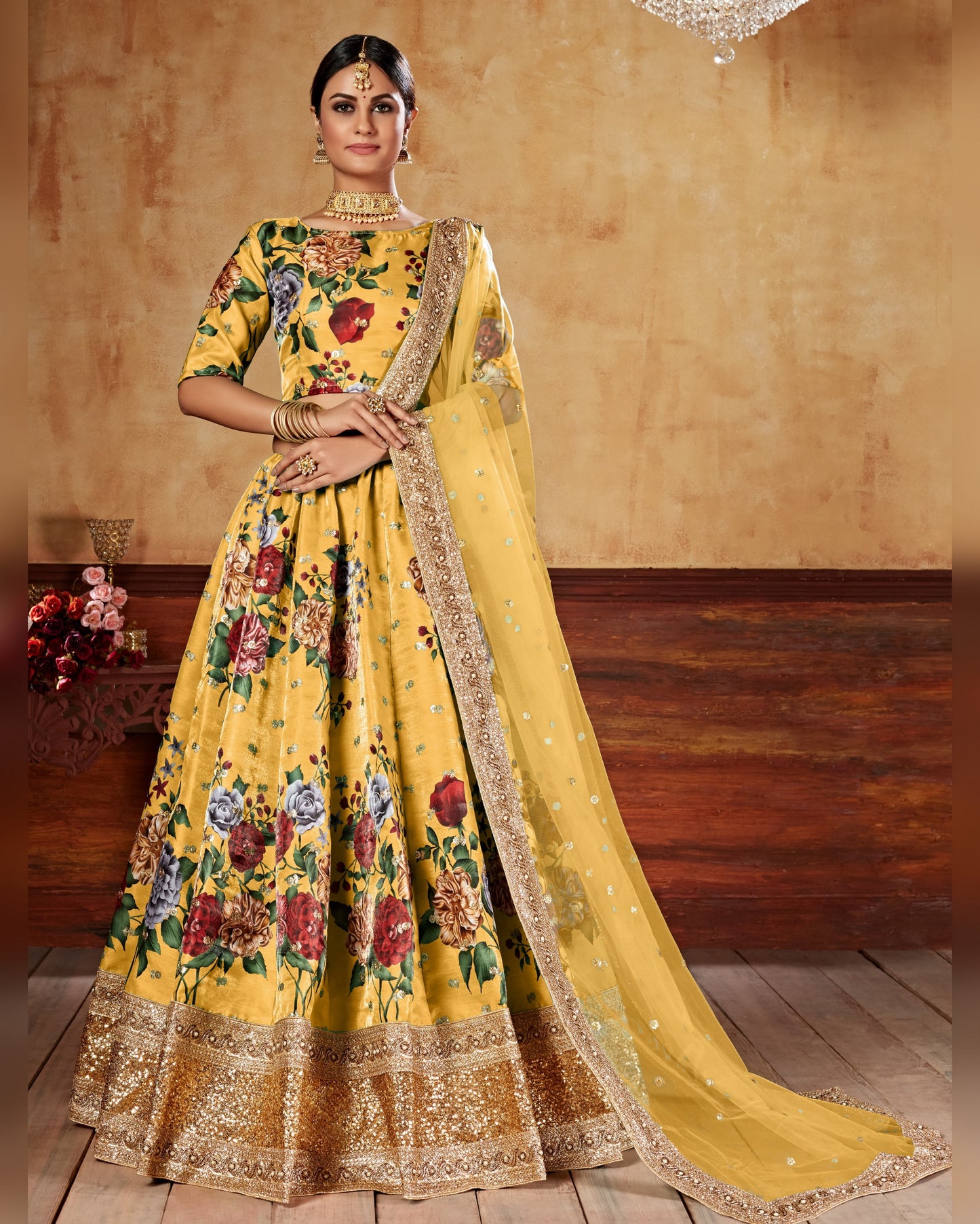 Yellow floral embroidered lehenga with dupatta on a wooden floor.