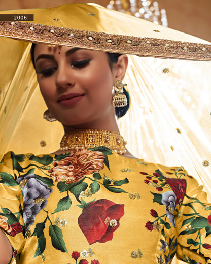 Woman wearing a yellow floral embroidered outfit with gold jewelry, 2006 text visible.