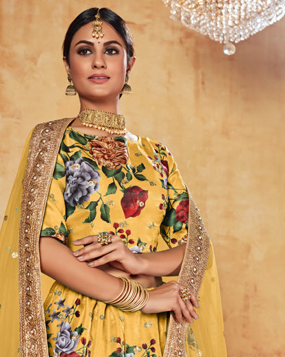 Woman in a yellow floral saree with gold jewelry against a beige background