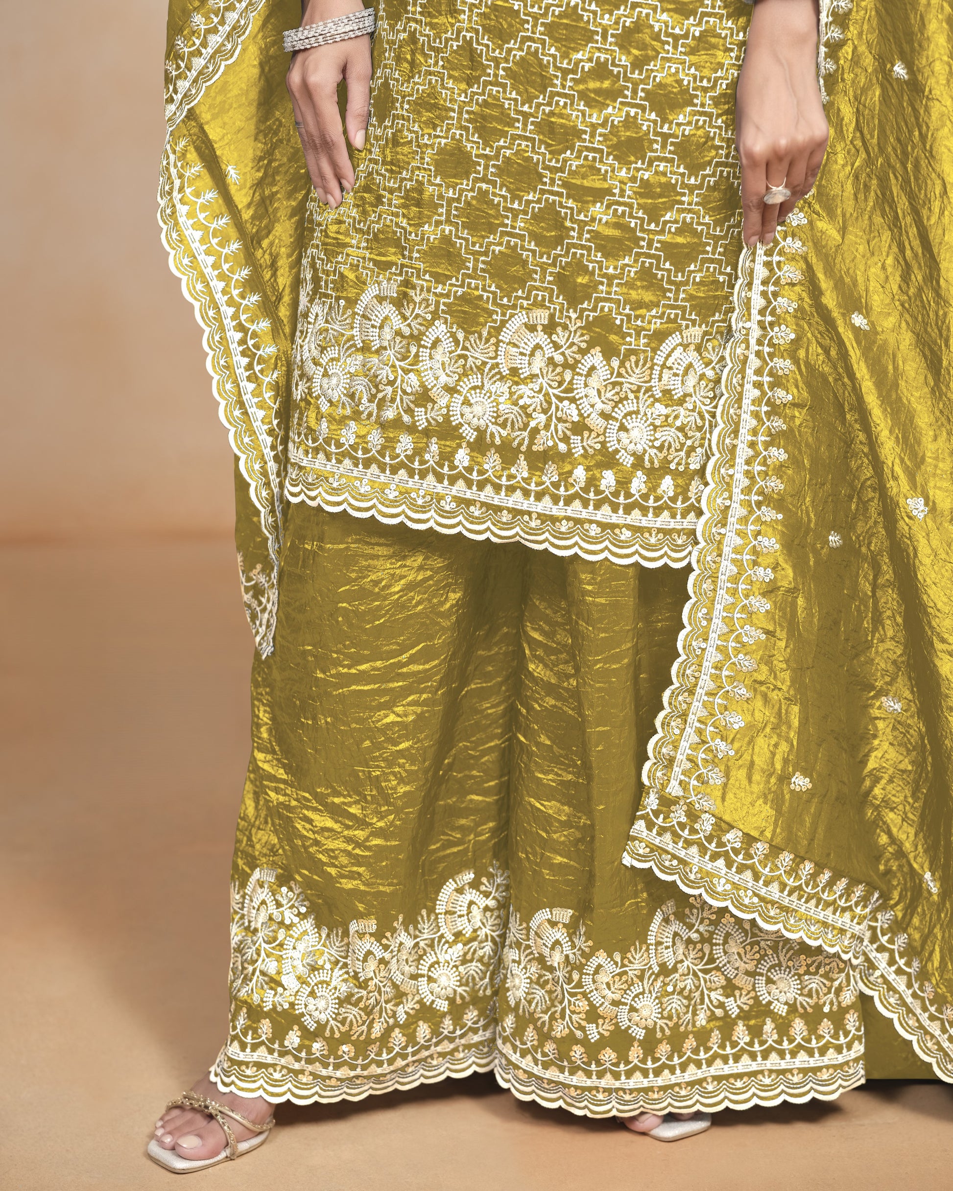 Yellow traditional outfit with white embroidery on a beige background