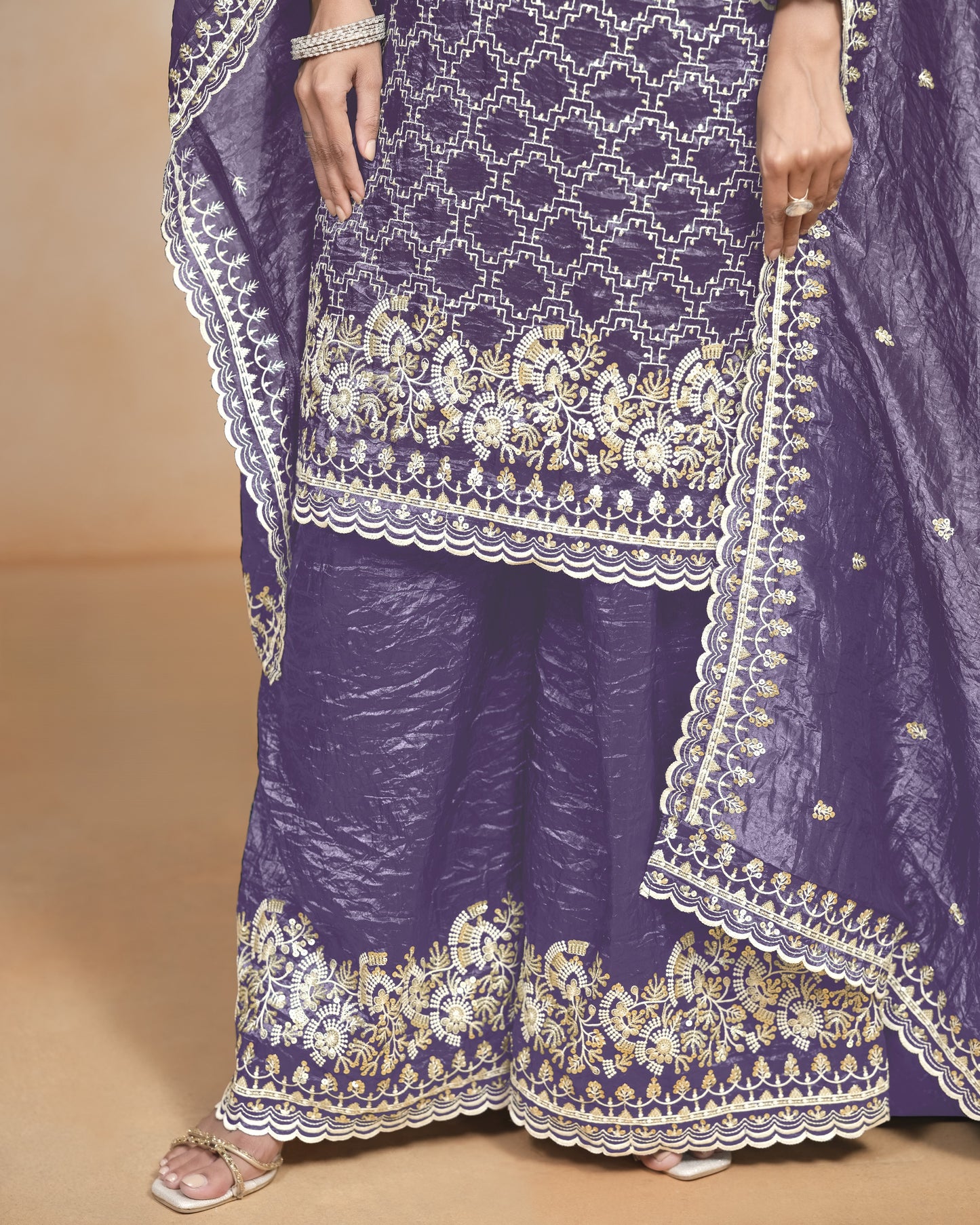 Purple traditional outfit with white embroidery on a beige background
