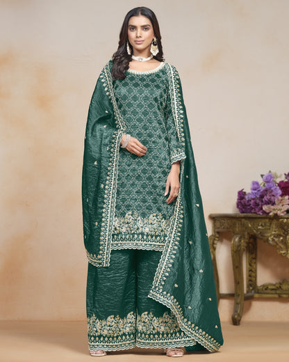 Woman wearing a green embroidered traditional outfit with a beige background