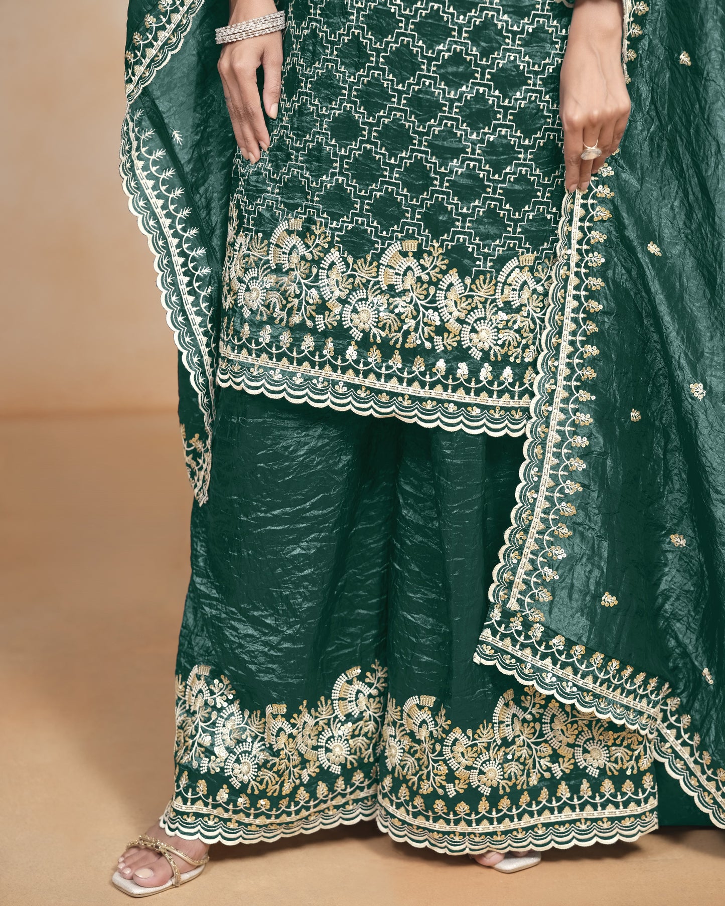 Green embroidered traditional outfit with a plain background
