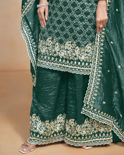 Green embroidered traditional outfit with a plain background