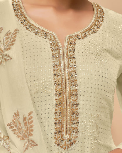 Close-up of a cream-colored garment with intricate gold embroidery
