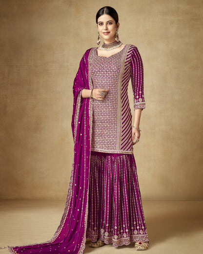 Woman wearing a traditional outfit with a purple and pink color scheme on a beige background