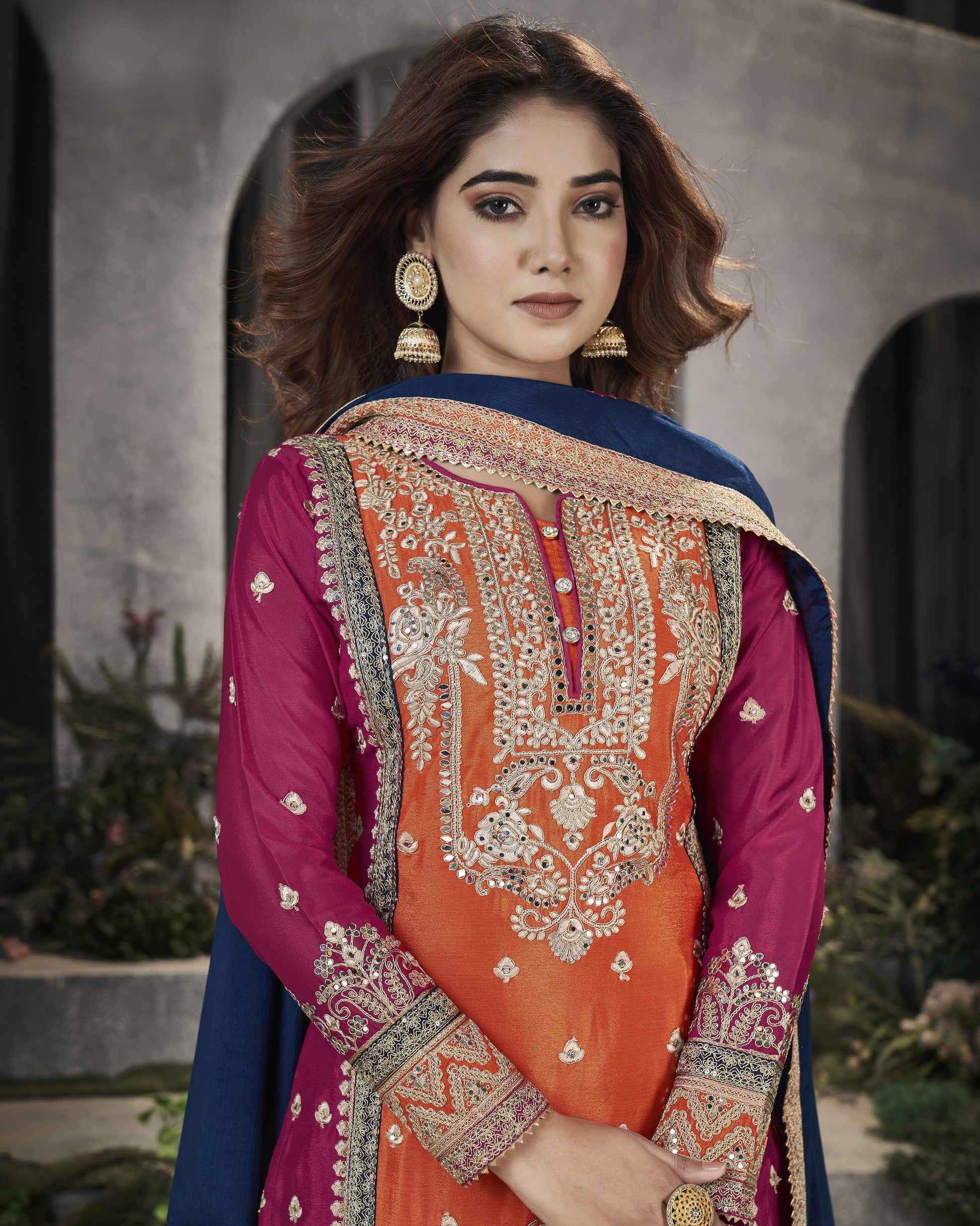 Woman wearing a traditional embroidered outfit with a blurred background