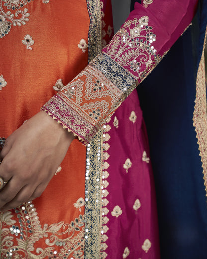 Close-up of a traditional embroidered garment with vibrant colors and intricate patterns.