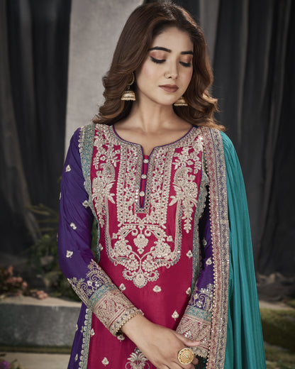 Woman wearing a traditional embroidered outfit with a dark background