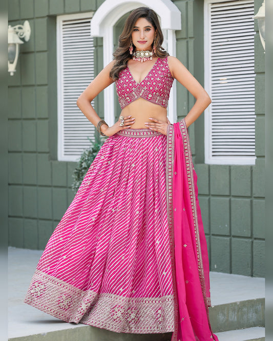 Woman wearing a pink traditional outfit with a green background