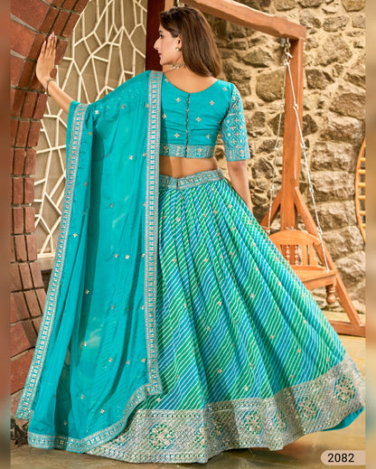 Woman wearing a turquoise traditional outfit with a stone wall and wooden swing in the background