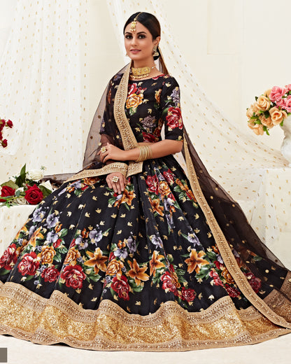 Woman wearing a black floral lehenga with gold border against a white background