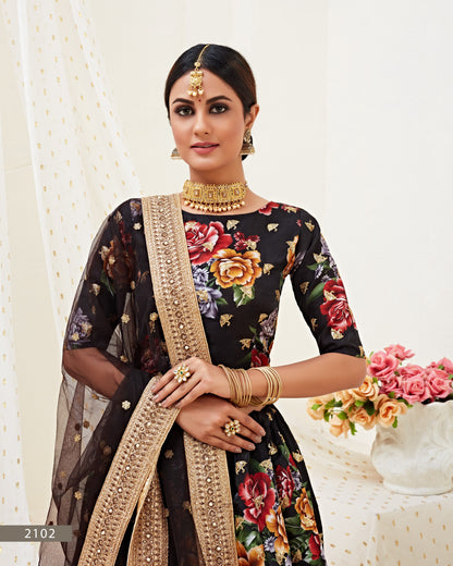 Woman wearing a floral saree with a gold border against a white background