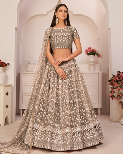 Woman in traditional embroidered outfit with floral decorations in a decorated room.