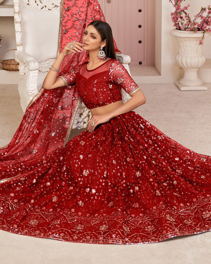 Woman in a red embroidered traditional outfit sitting on a white chair.