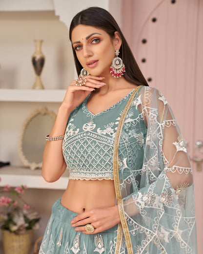 Woman wearing a traditional outfit with intricate designs in a decorative setting