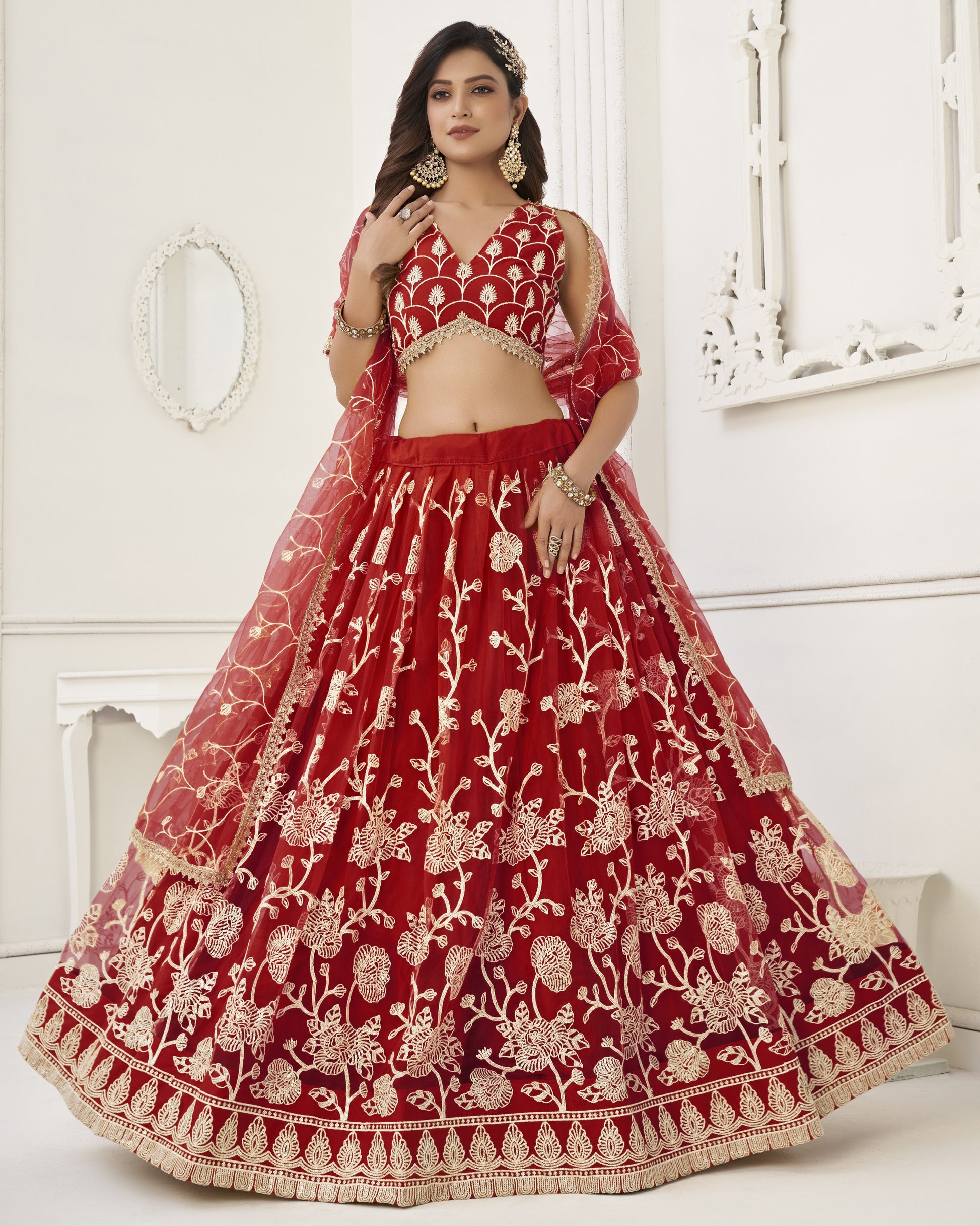 Red embroidered traditional outfit with gold details on a white background