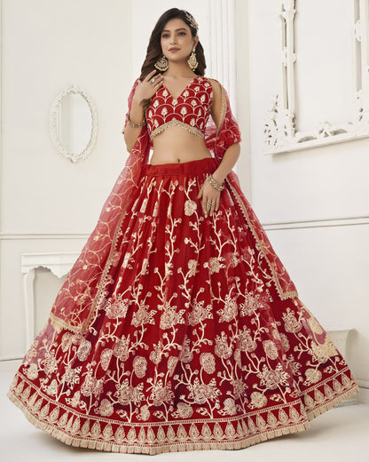 Red embroidered traditional outfit with gold details on a white background