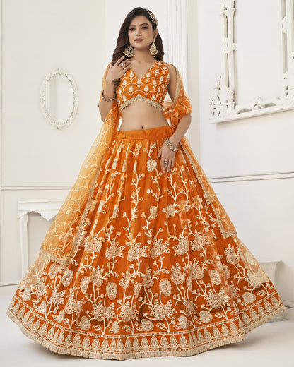 Woman wearing an orange embroidered traditional outfit in a white room.