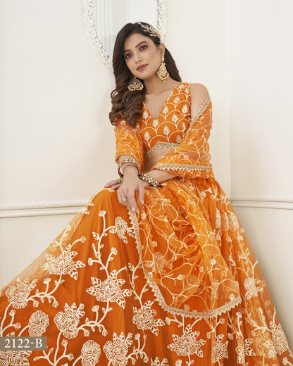 Woman wearing an orange and white embroidered traditional outfit against a white background