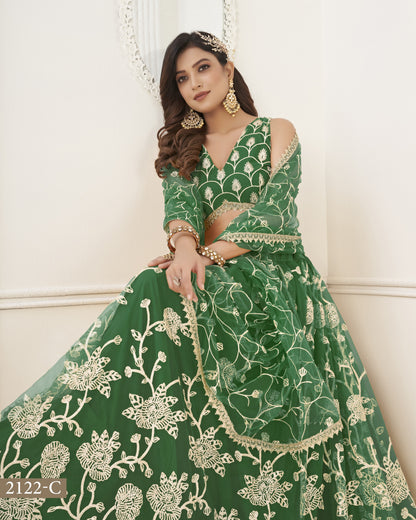 Woman wearing a green embroidered traditional outfit with a white background