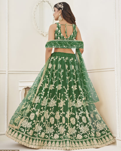 Green embroidered lehenga with gold detailing on a white background