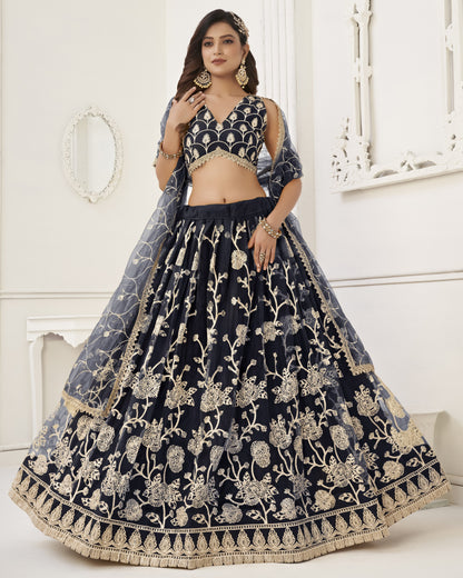 Navy blue embroidered lehenga with gold details on a white background