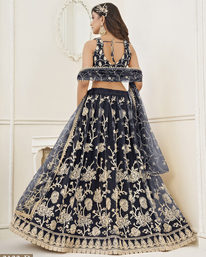 Navy blue embroidered lehenga with gold details on a white background