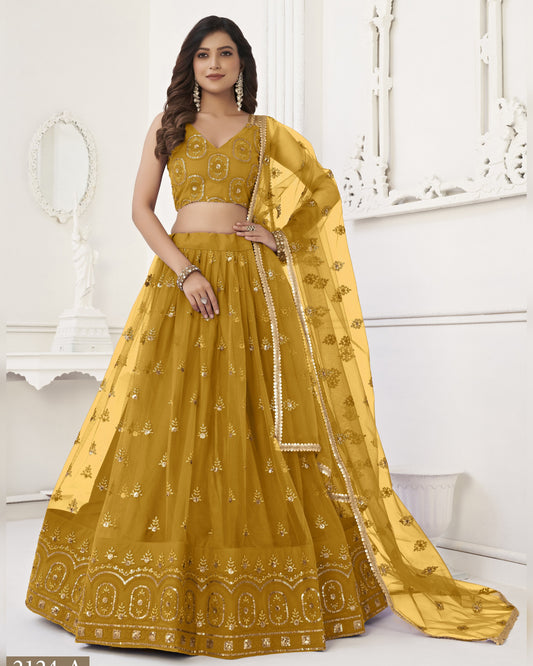 Woman wearing a yellow embroidered lehenga with a white background